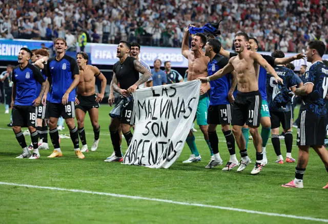 The Argentina players celebrate at full time with a banner