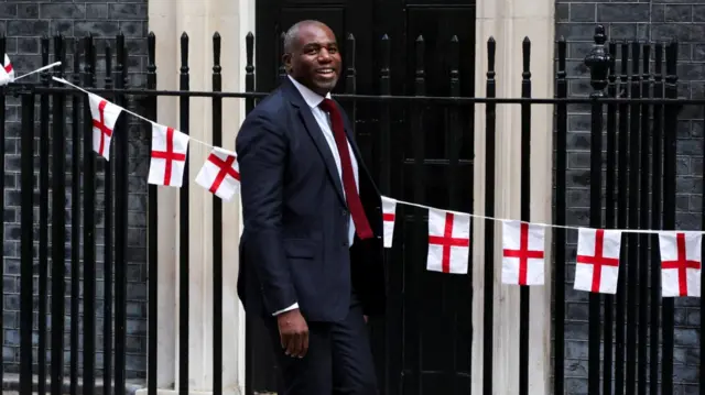 Deputy Prime Minister and Justice Secretary David Lammy walks past bunting with St George's Cross flags at Downing Street, on the day of a cabinet meeting, in London, Britain, July 15, 2026