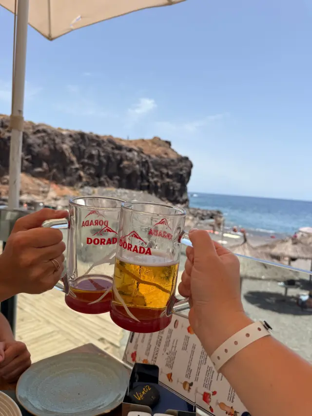Two people holding beers