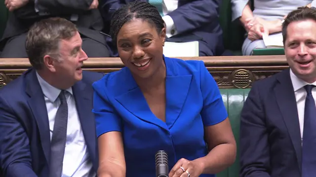 Kemi Badenoch wearing a blue dress