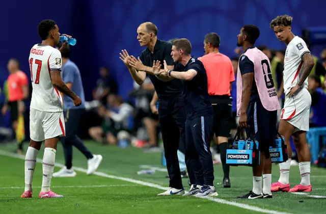 Thomas Tuchel, Manager of England, and Anthony Barry, Assistant Manager of England, speak with Morgan Rogers