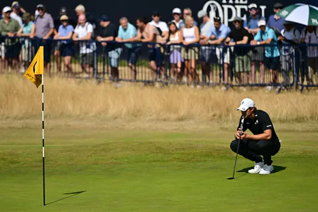 Thomas Detry libnes up a putt on the 18th green