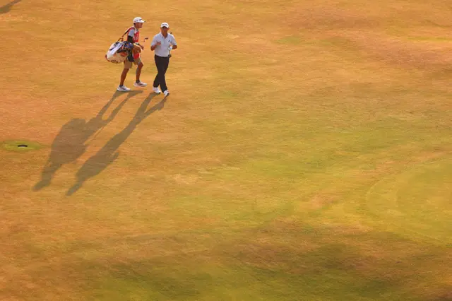Collin Morikawa of the United States and caddie Mark Urbanek on the 18th green