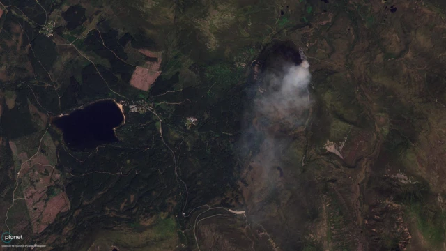 Smoke issues from a wildfire in a satellite image captured yesterday