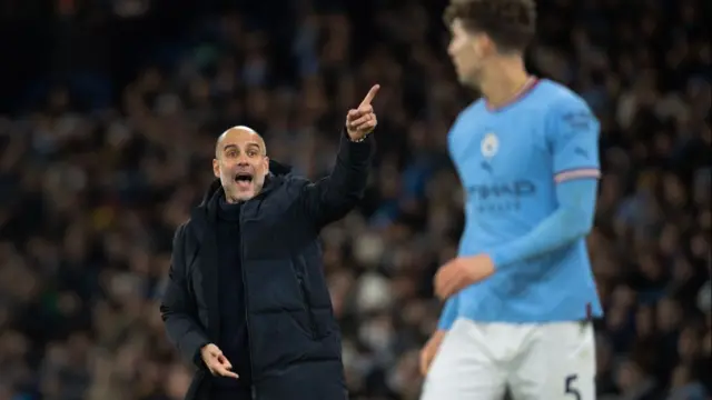 Manchester City manager Pep Guardiola shouts instructions to John Stones during the Premier League match between Manchester City and Tottenham Hotspur at Etihad Stadium on January 19, 2023 in Manchester, United Kingdom.