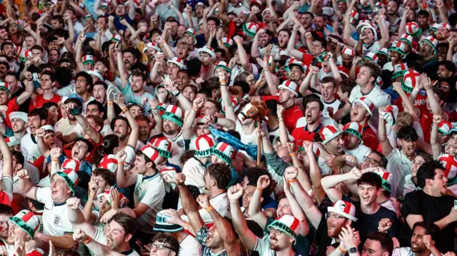 England supporters celebrate after the team's first goal as they watch a live broadcast of the 2026 World Cup semifinal football match between England and Argentina, at Boxpark Wembley in London on July 15, 2026.