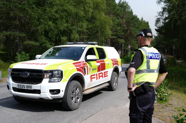 fire service 4x4 vehicle and police officer standing alongside
