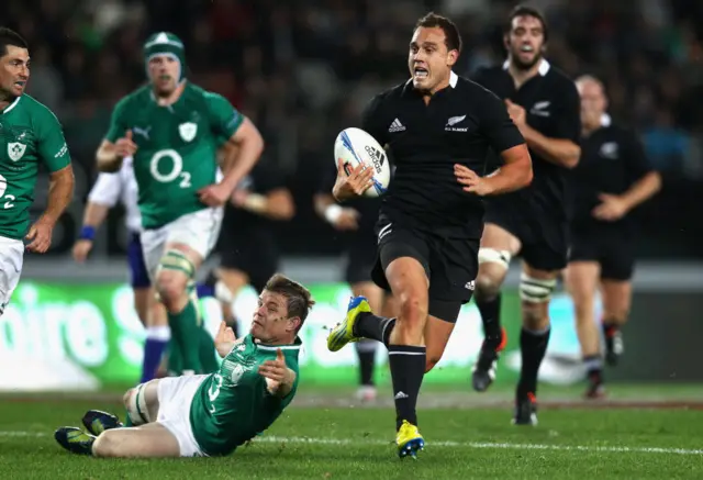Israel Dagg of the All Blacks breaks through the tackle of Brian O'Driscoll