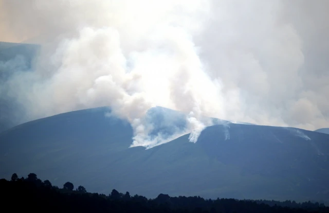 smoke on a grey hillside