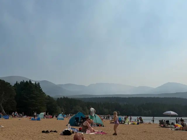 Smoke makes the sky hazy over Loch Morlich beach