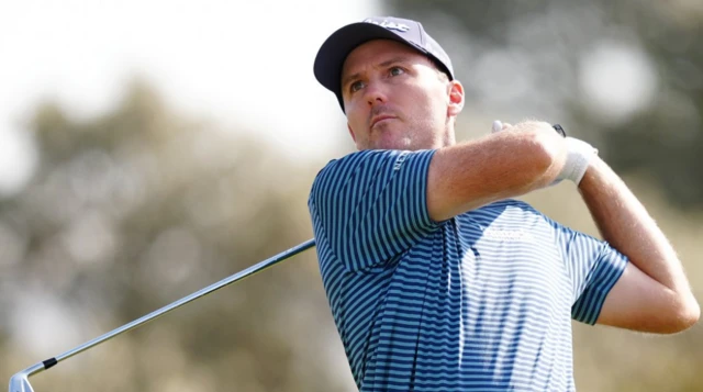 Russell Henley of the USA tees off the 2nd during day one