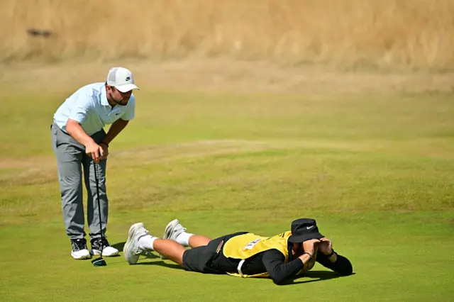 England's Alex Fitzpatrick and his caddie line up a putt