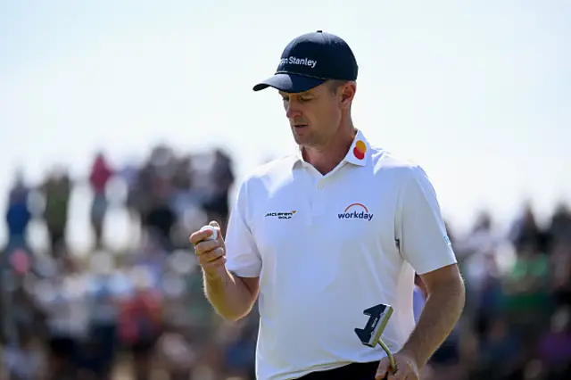 Justin Rose of England holds his ball