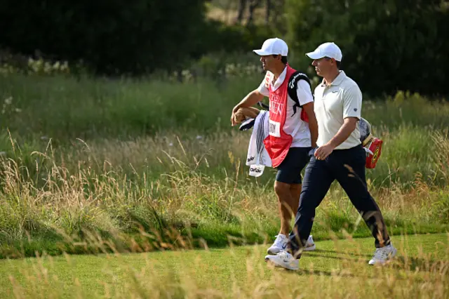 Rory McIlroy of Northern Ireland walks with his caddie Harry Diamond