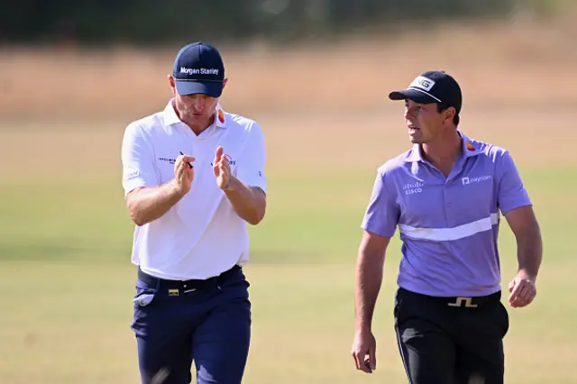 Justin Rose of England and Viktor Hovland of Norway walk