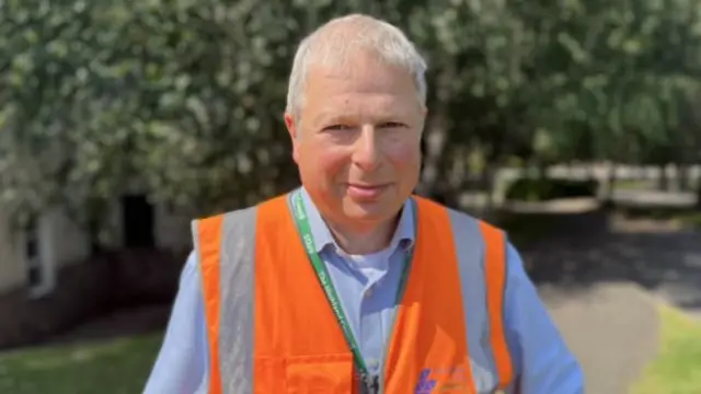 man in organge hi vis vest