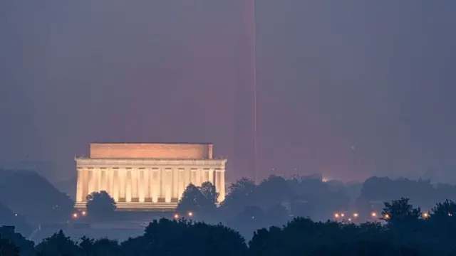 Smoke shrouds the Lincoln Memorial, Washington Monument, and the US Capitol Building Dome