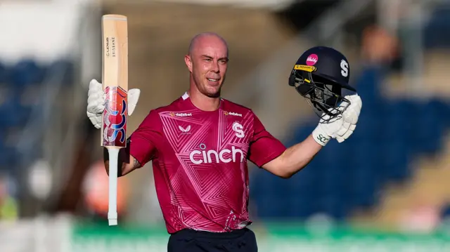 Chris Lynn with his bat in his right hand and helmet in his left after scoring a century for Northants v Glamorgan