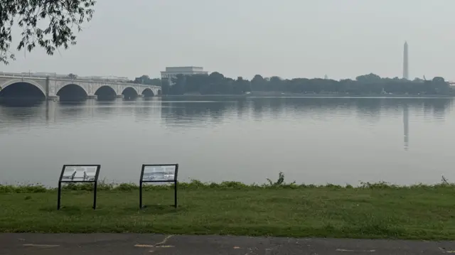 Washington DC can be seen from across the river, hazy and covered in smoke