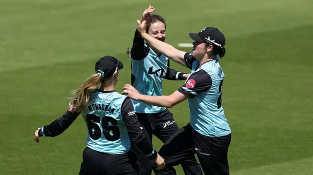 Surrey Women - including Alice Monaghan, wearing the number 66 - celebrate