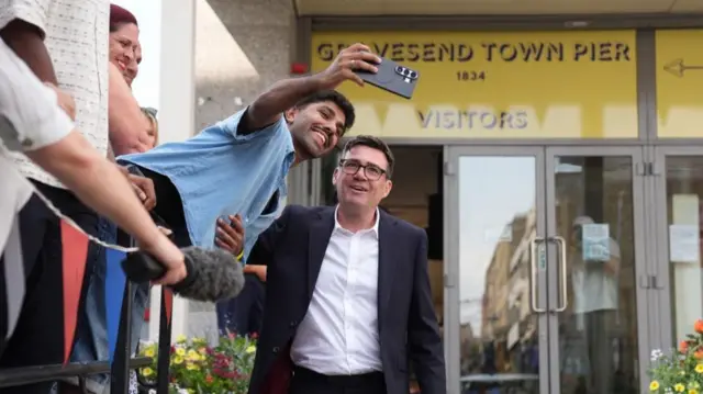 Andy Burnham takes a selfie with a man outside Gravesend Town Pier