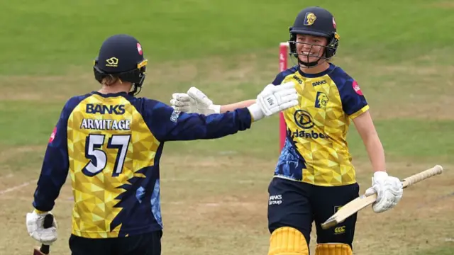 Durham Women batters, including captain Holly Armitage (left), celebrate while batting