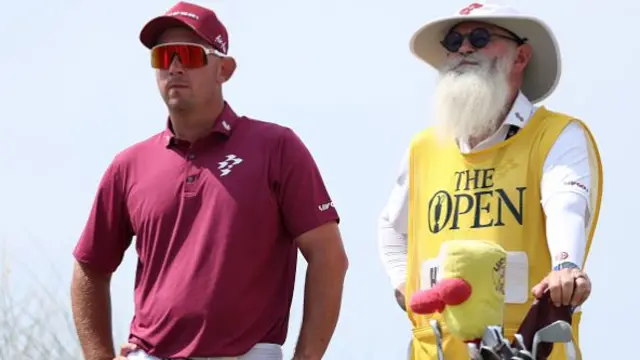 Lucas Herbert of Australia interacts with his caddie, Nick Pugh