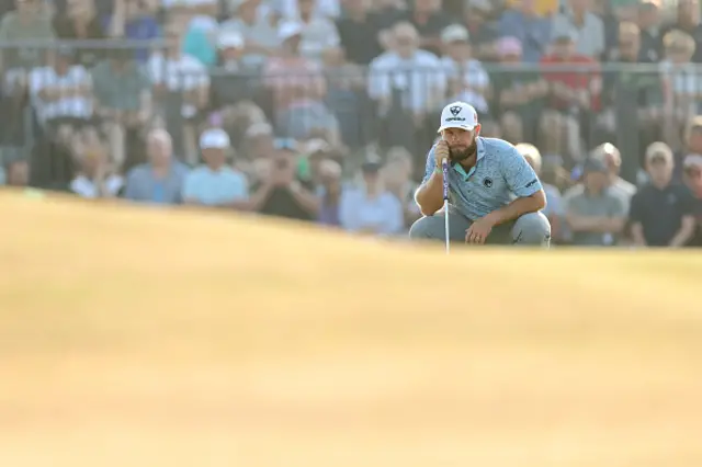 Tyrrell Hatton of England lines up a putt on the 14th green