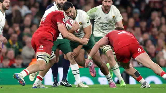 South Africa centre Damian de Allende carries the ball into the Wales defence
