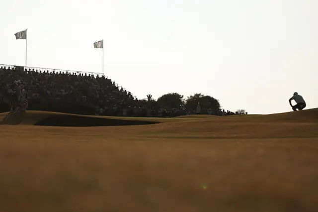 Scottie Scheffler of the United States lines up putt