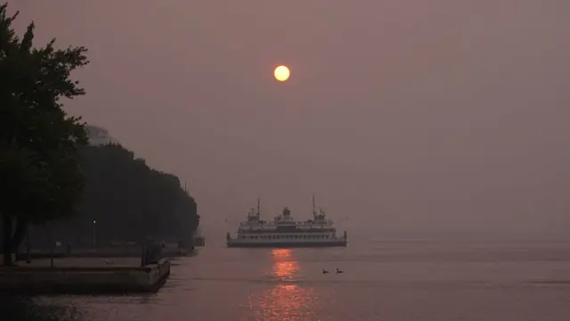 The sun rises over Toronto's waterfront through dense wildfire smoke for a second consecutive day as poor air quality persists across the city, in Toronto, Ontario, Canada, on July 16, 2026. (Photo by Arrush Chopra/NurPhoto via Getty Images)
