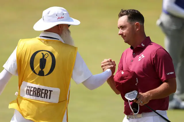Lucas Herbert of Australia shakes hands with his caddie, Nick Pugh