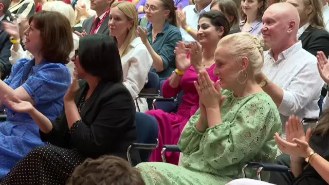 Lucy Powell, Shabana Mahmood and Burnham's wife, Marie-France van Heel, applaud during the speech