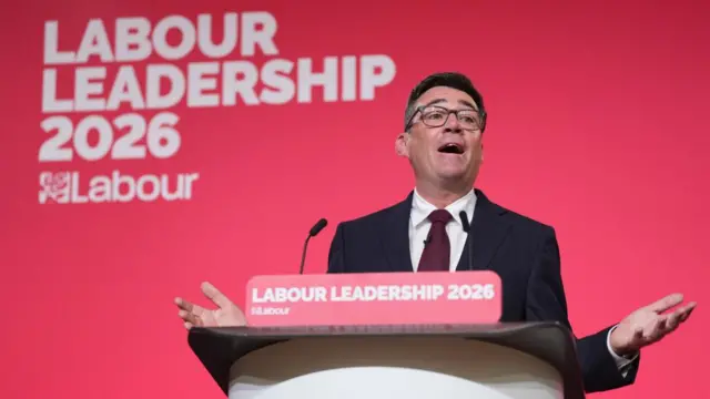 Andy Bunham speaking into a lectern. The sign behind him and on the lectern read: Labour leadership 2026