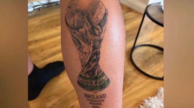 A leg with a tattoo of the World Cup trophy and the caption 'England World Cup winners 2026'