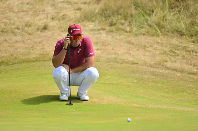Australia's Lucas Herbert lines up his putt on the 17th green