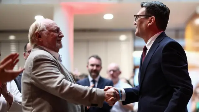 Neil Kinnock and Andy Burnham shake hands