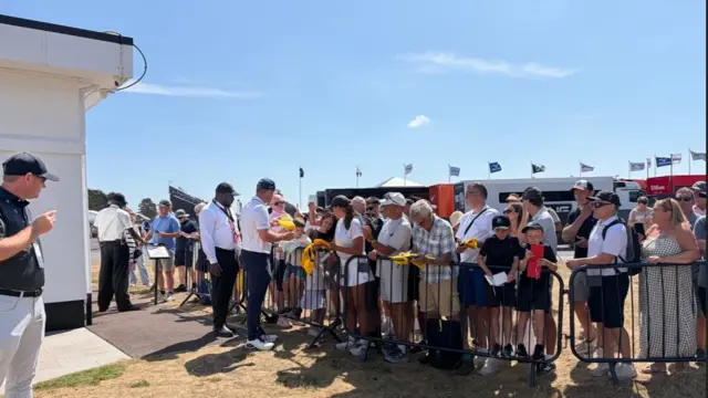 Bryson Dechambeau signs autographs