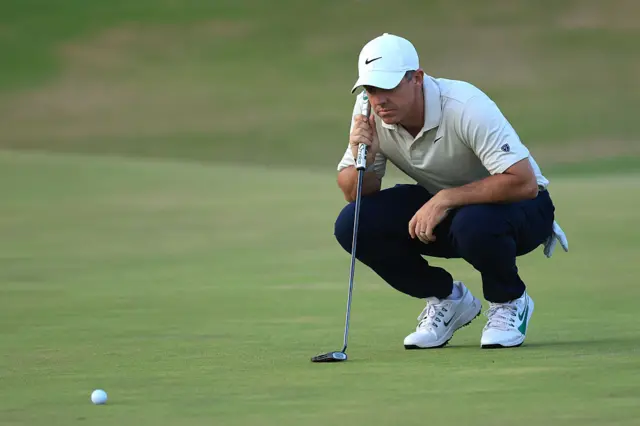 Rory McIlroy lines up at putt in the opening round of the 2026 Open
