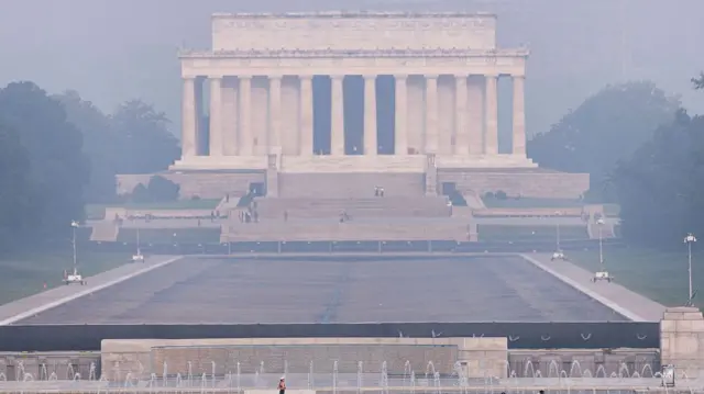 Smoke from massive wildfires in Canada and Minnesota engulf the Washington, D.C. skyline, reducing visibility and casting a colored haze over the Lincoln Memorial.