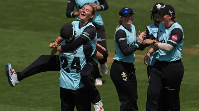 Tilly Corteen-Coleman is hoisted aloft after her wicket