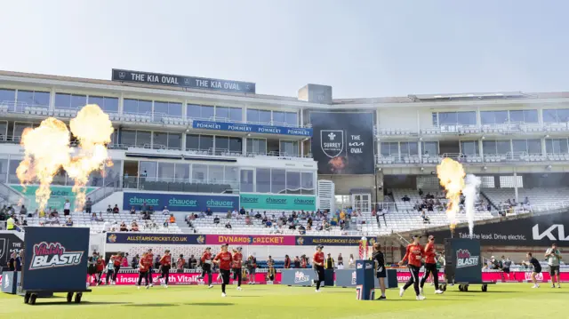 The players enter the field with pyrotechnics either side