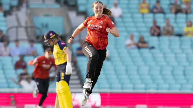 Grace Ballinger jumps celebrating a wicket
