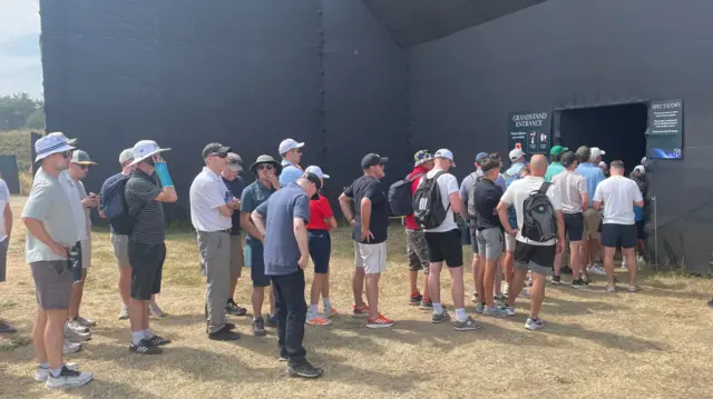 Fans queue to get to the 18th green