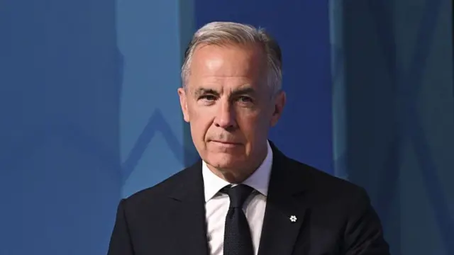 Canadian Prime Minister Mark Carney in a dark suit and tie.