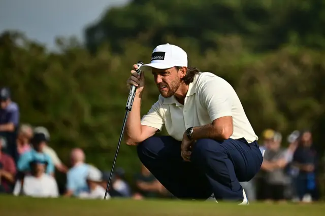 Tommy Fleetwood sizes up a putt