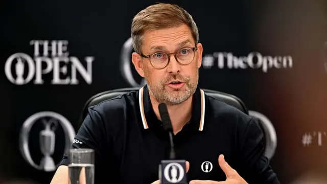 Mark Darbon speaks at a media conference