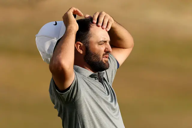 Scottie Scheffler holds his head