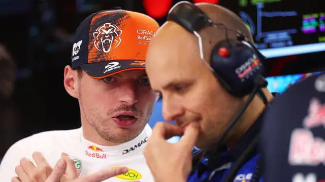 Max Verstappen in the garage talking to his engineer
