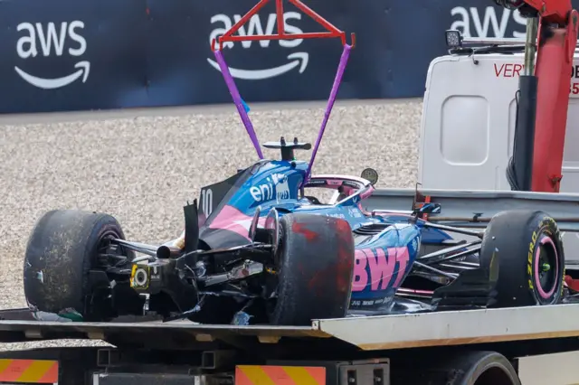 Pierre Gasly's car is taken away after his crash in FP2